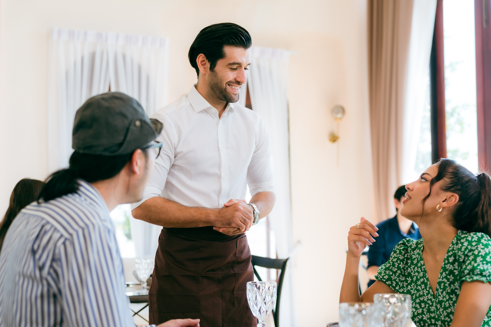 Server providing excellent customer service in restaurant dining room