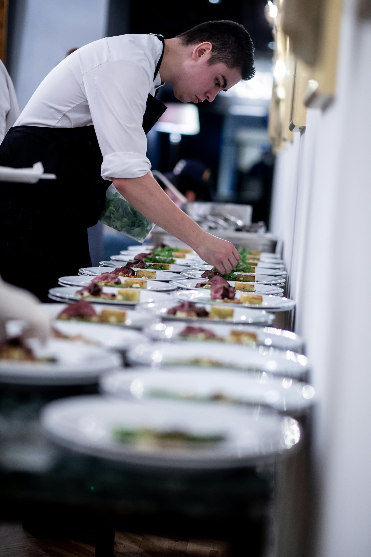 Chef working on multiple plates